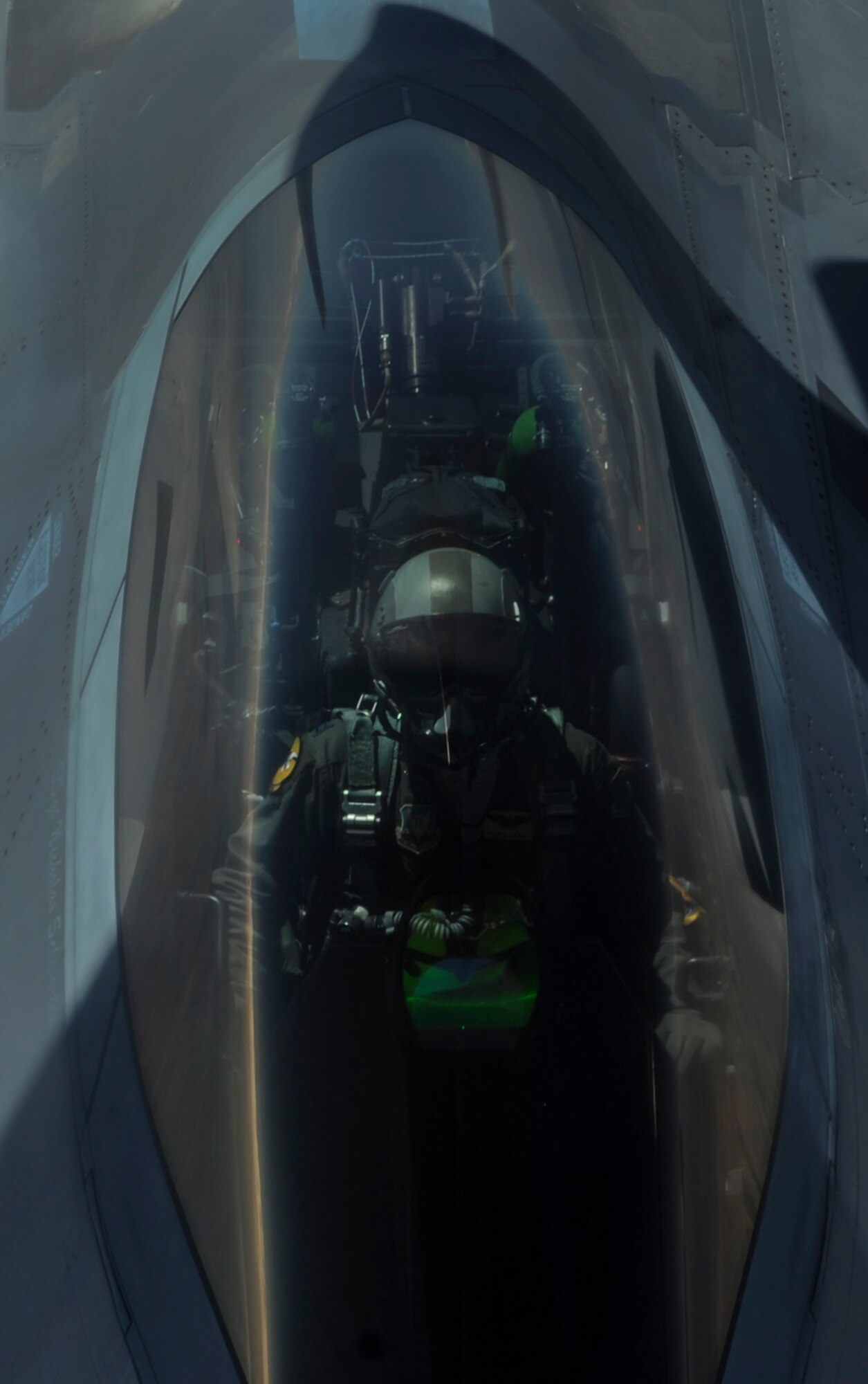 An F-22A Raptor pilot, assigned to the 27th Fighter Squadron, Joint Base Langley-Eustis, Va., waits as a KC-135 in-air refuels the aircraft during Red Flag 16-3 over the Nevada Test and Training Range, Nev., July 27, 2016. Red Flag missions are conducted 2.9 million acres of the NTTR with 1,900 possible targets, realistic threat systems and opposing enemy forces. (U.S. Air Force photo by Airman 1st Class Kevin Tanenbaum/Released)