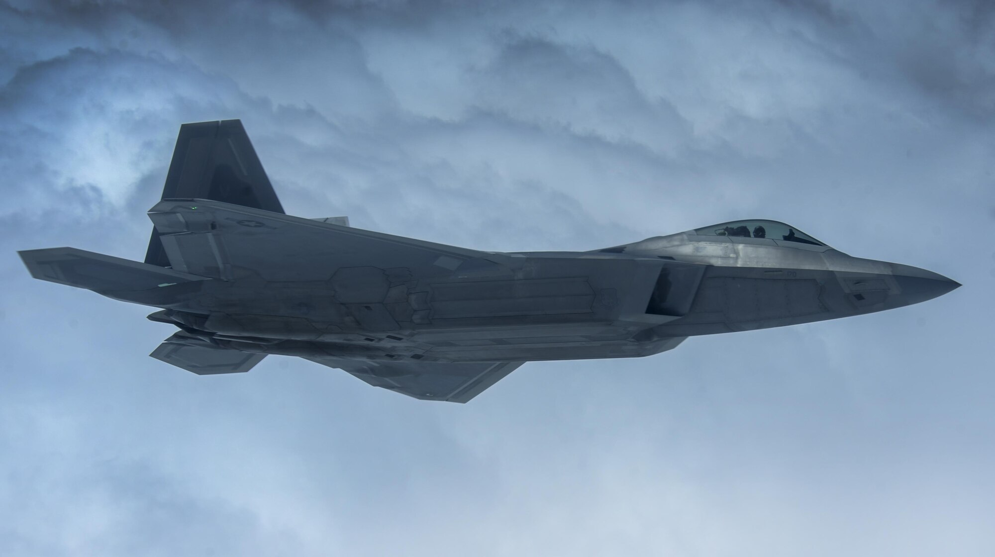 An F-22A Raptor, assigned to the 27th Fighter Squadron, Joint Base Langley-Eustis, Va., flies over the Nevada Test and Training Range, Nev., during Red Flag 16-3, July 27, 2016. Red Flag is an exercise hosted at Nellis Air Force Base, Nev. that provides aircrews and opportunity to experience realistic combat situations in a controlled environment. (U.S. Air Force photo by Airman 1st Class Kevin Tanenbaum/Released)