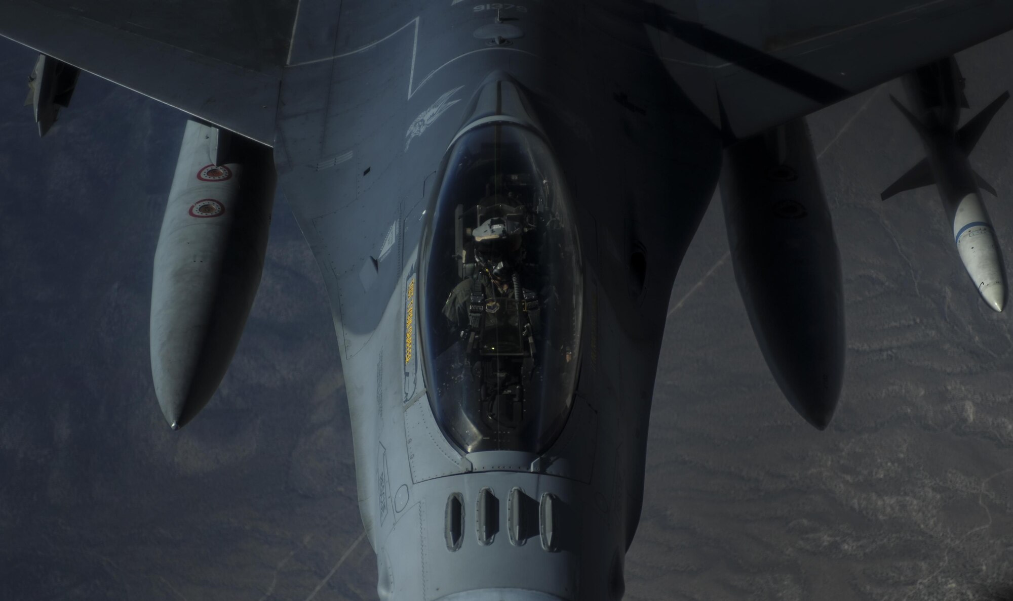 An F-16CJ pilot assigned to the 79th Fighter Squadron, Shaw Air Force Base, S.C., waits as the jet receives mid-air refueling during Red Flag 16-3 over the Nevada Test and Training Range, July 27, 2016. Red Flag was established in 1975 as one initiative of directed by General Robert J. Dixon, then commander of the Tactical Air Command, to better prepare U.S. forces for combat. (U.S. Air Force photo by Airman 1st Class Kevin Tanenbaum/Released)
