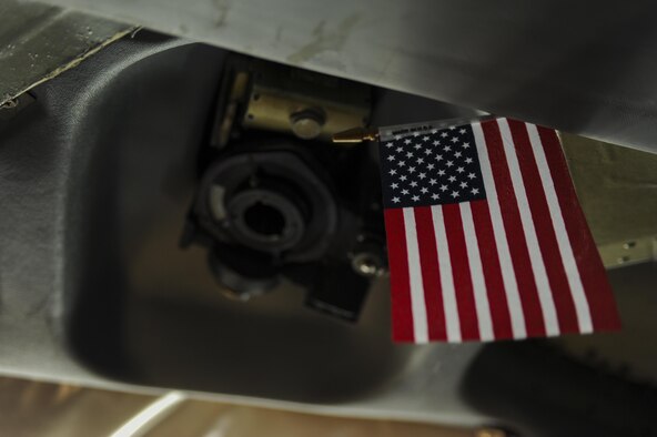 An American flag hangs in the cockpit of a KC-135 Stratotanker, assigned to the 22nd Air Refueling Wing, McConnell Air Force Base, Kan., during Red Flag 16-3 at Nellis Air Force Base, Nev., July 27, 2016. Red Flag enhances aircrew’s combat readiness and survivability by challenging them with realistic combat scenarios. (U.S. Air Force photo by Airman 1st Class Kevin Tanenbaum/Released)