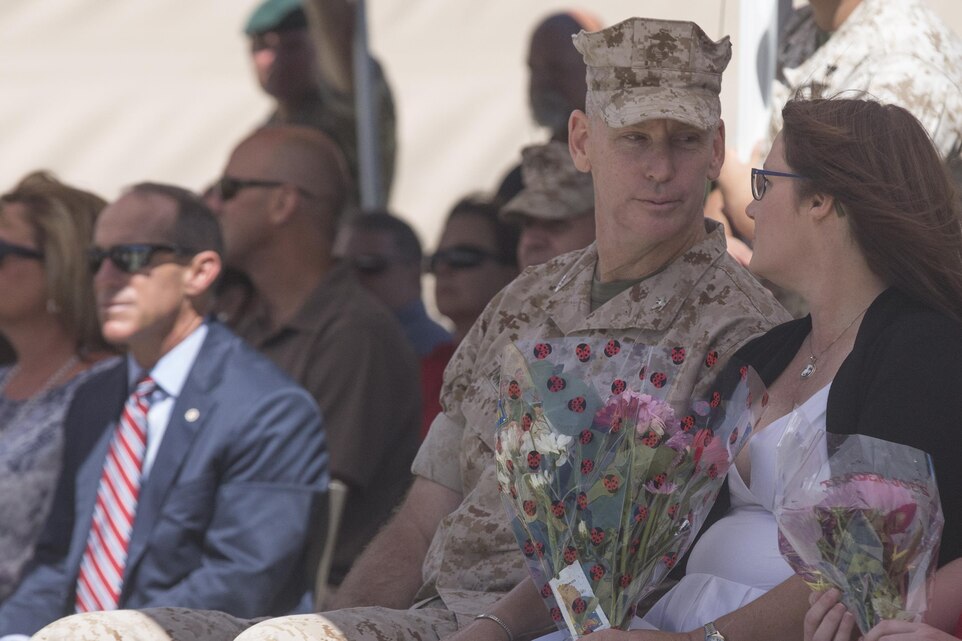 Colonel James E. Donnellan, oncoming commanding officer, Marine Corps Mountain Warfare Training Center, shares a moment with his wife during the MCMWTC’s change of command ceremony at the expeditionary airfield, July 22, 2016. During the ceremony, Col. Scott D. Leonard, outgoing commanding officer, MCMWTC, relinquished command to Donnellan. (Official Marine Corps photo by Cpl. Medina Ayala-Lo/Released)