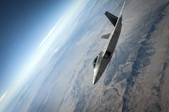 An F-22A Raptor assigned to the 27th Fighter Squadron, Joint Base Langley-Eustis, Virginia, banks aggressively in the skies over the Nevada Test and Training Range during a Red Flag 16-3 training sortie July 22, 2016 at Nellis AFB, Nev.  Red Flag exercises bring joint and coalition air, space and cyber units together against a common adversary in order to further build tactical cohesion. (U.S. Air Force photo by Senior Airman Joshua Kleinholz)