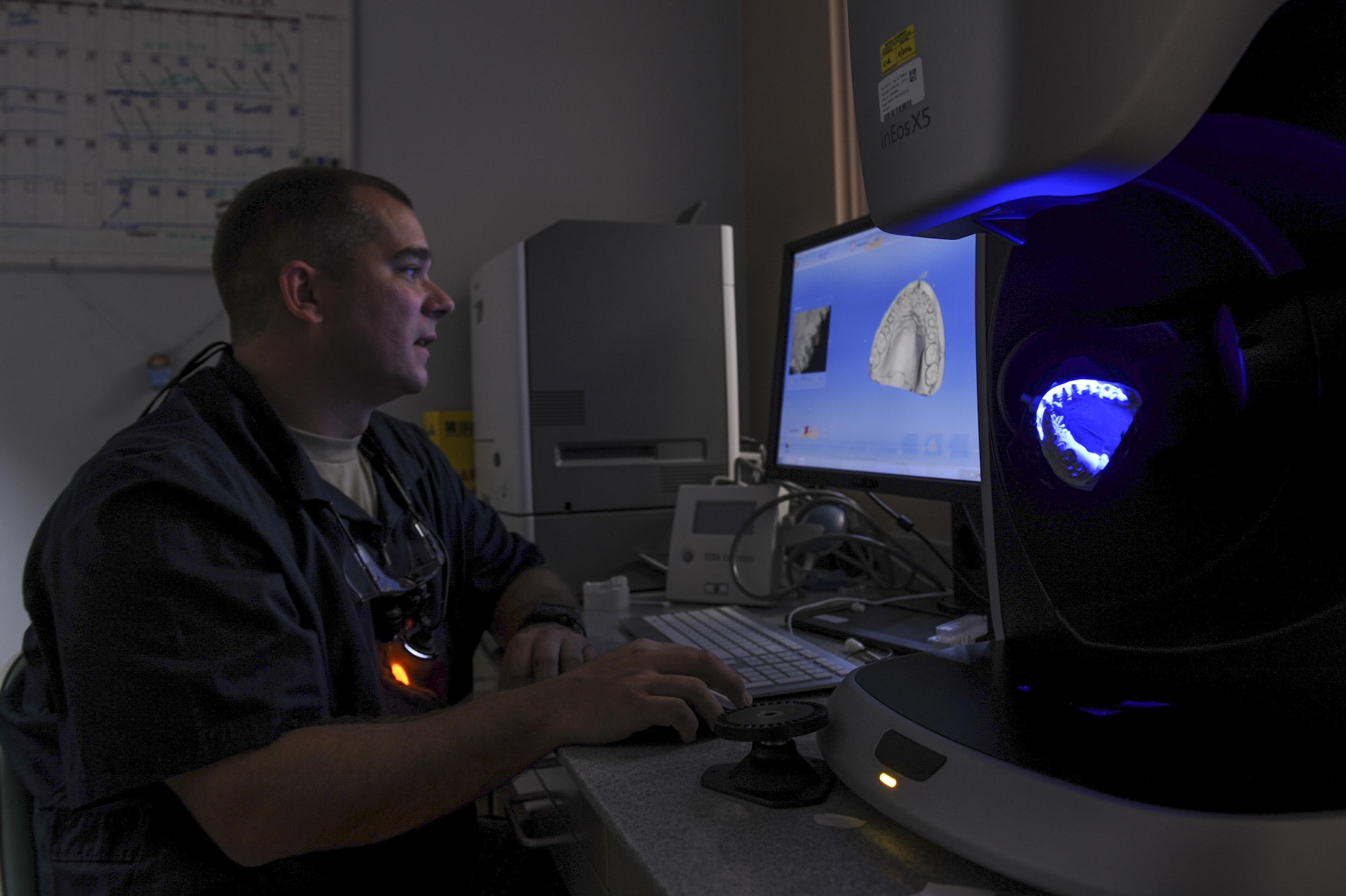 U.S. Air Force Staff Sgt. Robert Thompson, 19th Aerospace Medicine Squadron dental laboratory noncommissioned officer in charge, analyzes the dentition of a patient with a computer-aided design and manufacturing machine July 27, 2016, at Little Rock Air Force Base, Ark. CAD/CAM dentistry utilizes new technology to improve the design and creation of dental restorations. (U.S. Air Force photo/Senior Airman Harry Brexel)