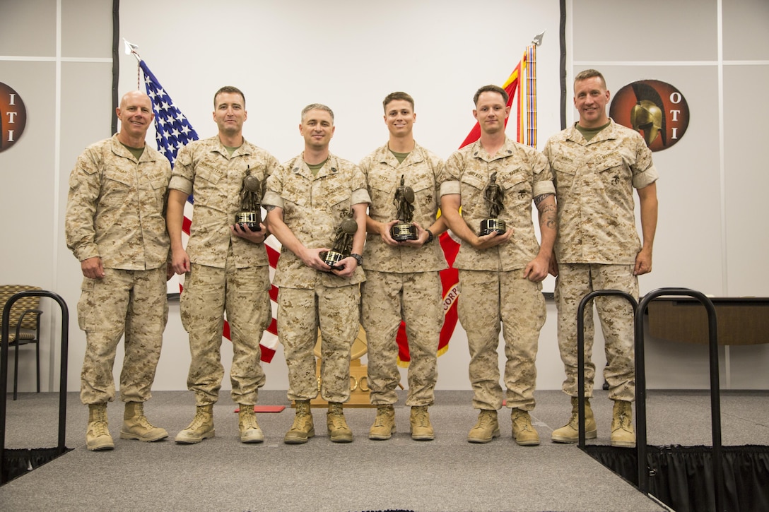 The honor graduates of Tactical Marine Air Ground Task Force Integration Course 2-16 present their awards during the graduation ceremony aboard the Marine Corps Air Ground Combat Center, Twentynine Palms, Calif., July 23, 2016. (Official Marine Corps photo by Lance Cpl. Alysa Jesse/Released)