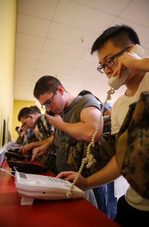 Recruits of Echo Company, 2nd Recruit Training Battalion, make their phone calls home, reading only what is printed on the script in front of them, during receiving at Marine Corps Recruit Depot San Diego, July 25. Recruits will not be able to make another phone call until the end of recruit training. Annually, more than 17,000 males recruited from the Western Recruiting Region are trained at MCRD San Diego. Echo Company is scheduled to graduate Oct. 21.