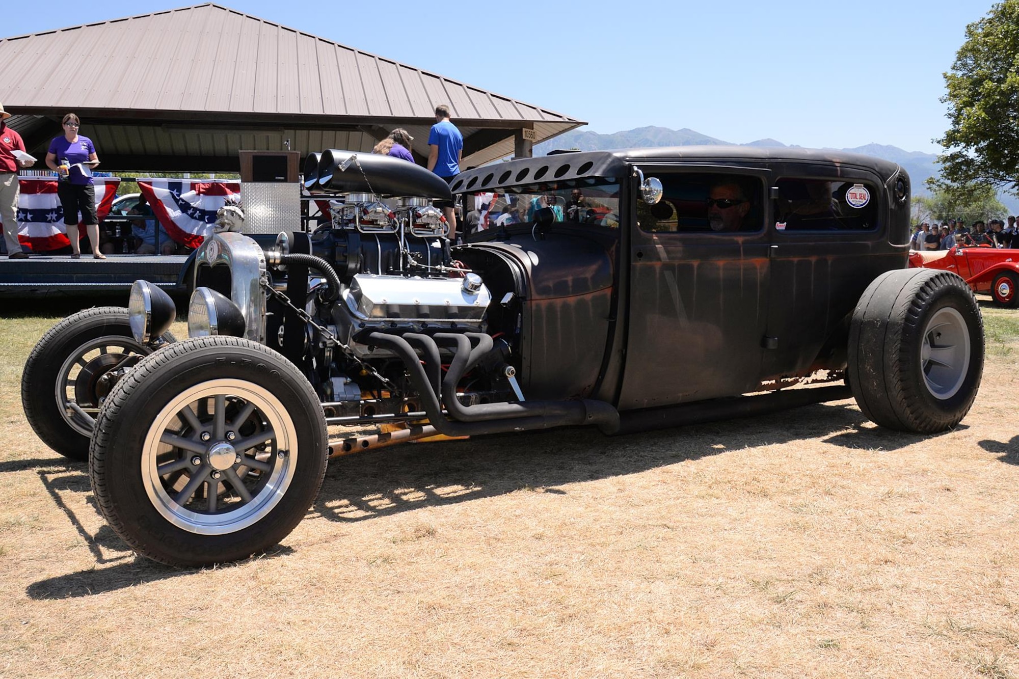 Rick Shelton, 572nd Aircraft Maintenance Squadron, drives his 1929 Ford two-door sedan to the winner’s podium. The vehicle received the Best Custom/Owner built award. (U.S. Air Force photo by Alex R. Lloyd)