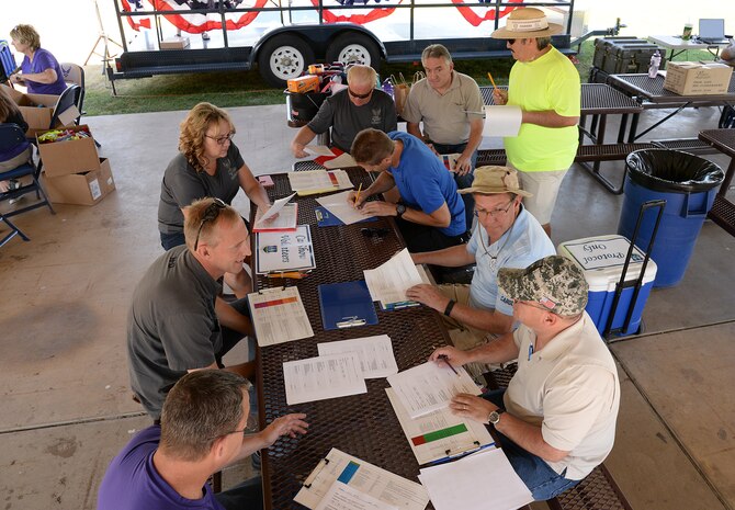 Judges take notes and make final preparations before looking at the more than 120 vehicles gathered for the car show. (U.S. Air Force photo by Alex R. Lloyd)