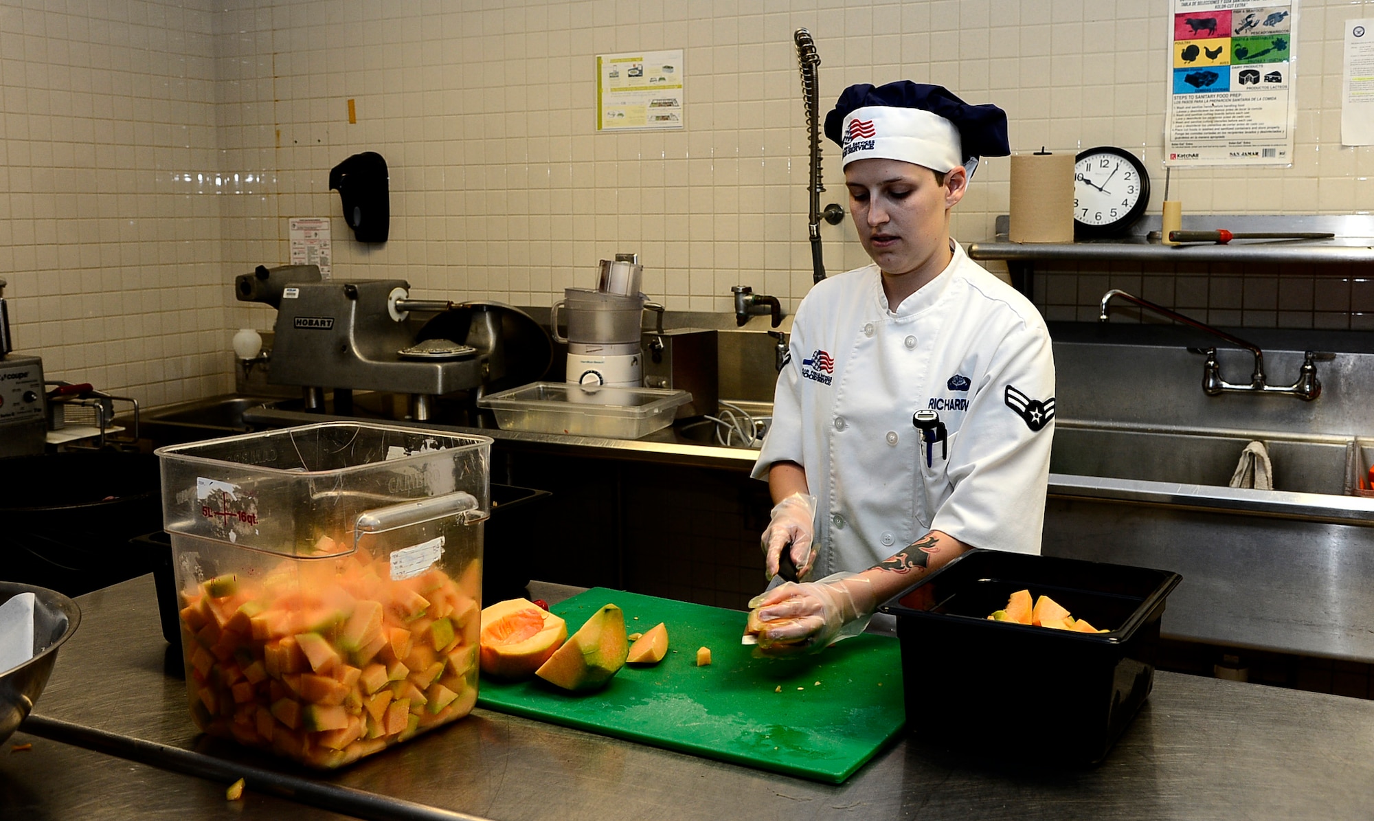 Airman 1st Class Lundia Richardson, a food specialist assigned to the 6th Force Support Squadron, cuts cantaloupe for fruit cups at MacDill Air Force Base, Fla., July 26, 2016. Richardson is in charge of keeping the fruit and salad bar stocked during meal times. (U.S. Air Force photo by Senior Airman Tori Schultz)