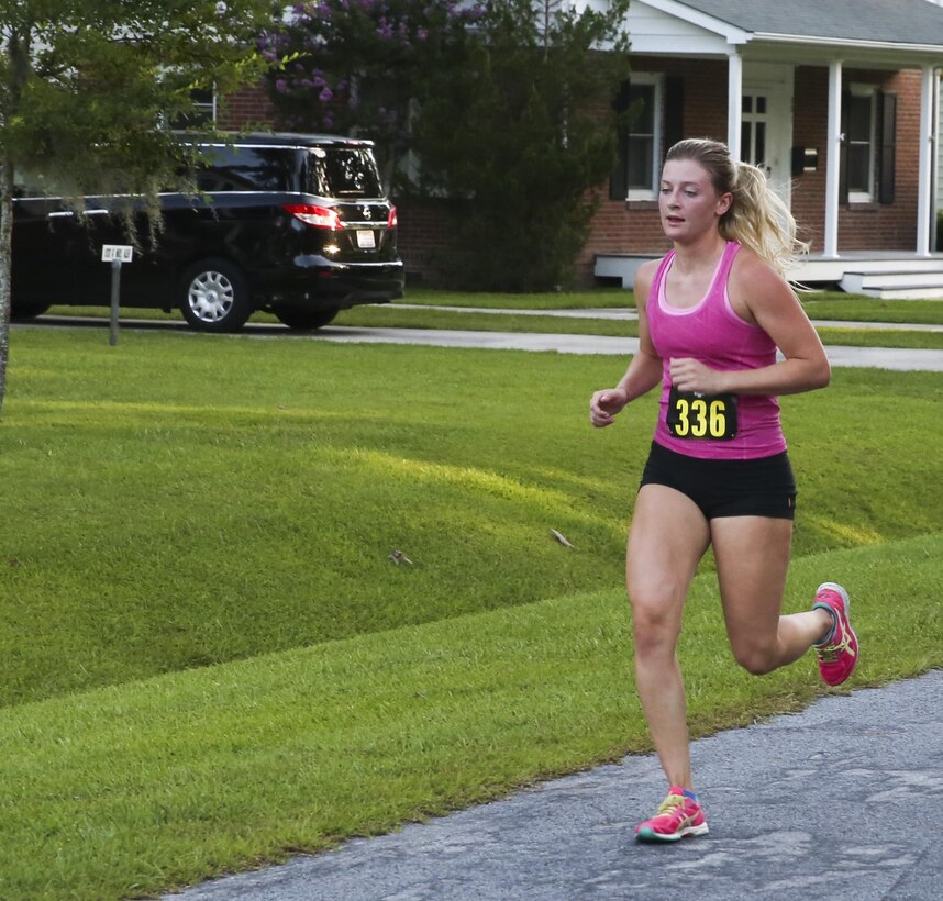 Sophie Curatilo runs to the finish line during the 7.5K Anniversary Run aboard Marine Corps Air Station Cherry Point, N.C., July 29, 2016. The run was to celebrate the 75th anniversary of MCAS Cherry Point and 2nd Marine Aircraft Wing. (Marine Corps photo by Lance Cpl. Cody Lemons/ Released)