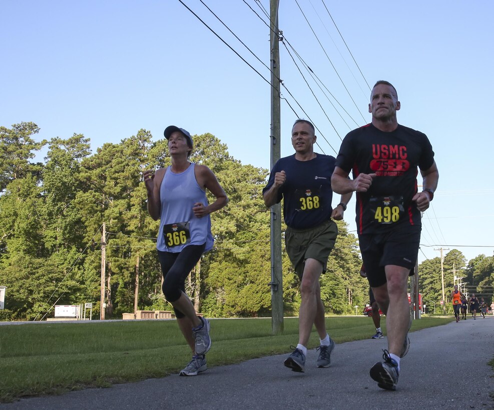 (Left to Right) Francine Glavy, Brig. Gen. Matthew Glavy and Sgt. Maj. Richard Thresher run to the finish line during the 7.5K Anniversary Run aboard Marine Corps Air Station Cherry Point, N.C., July 29, 2016. The run was to celebrate the 75th anniversary of MCAS Cherry Point and 2nd Marine Aircraft Wing. Thresher is the sergeant major and Glavy is the commanding general of 2nd MAW. (Marine Corps photo by Lance Cpl. Cody Lemons/ Released)