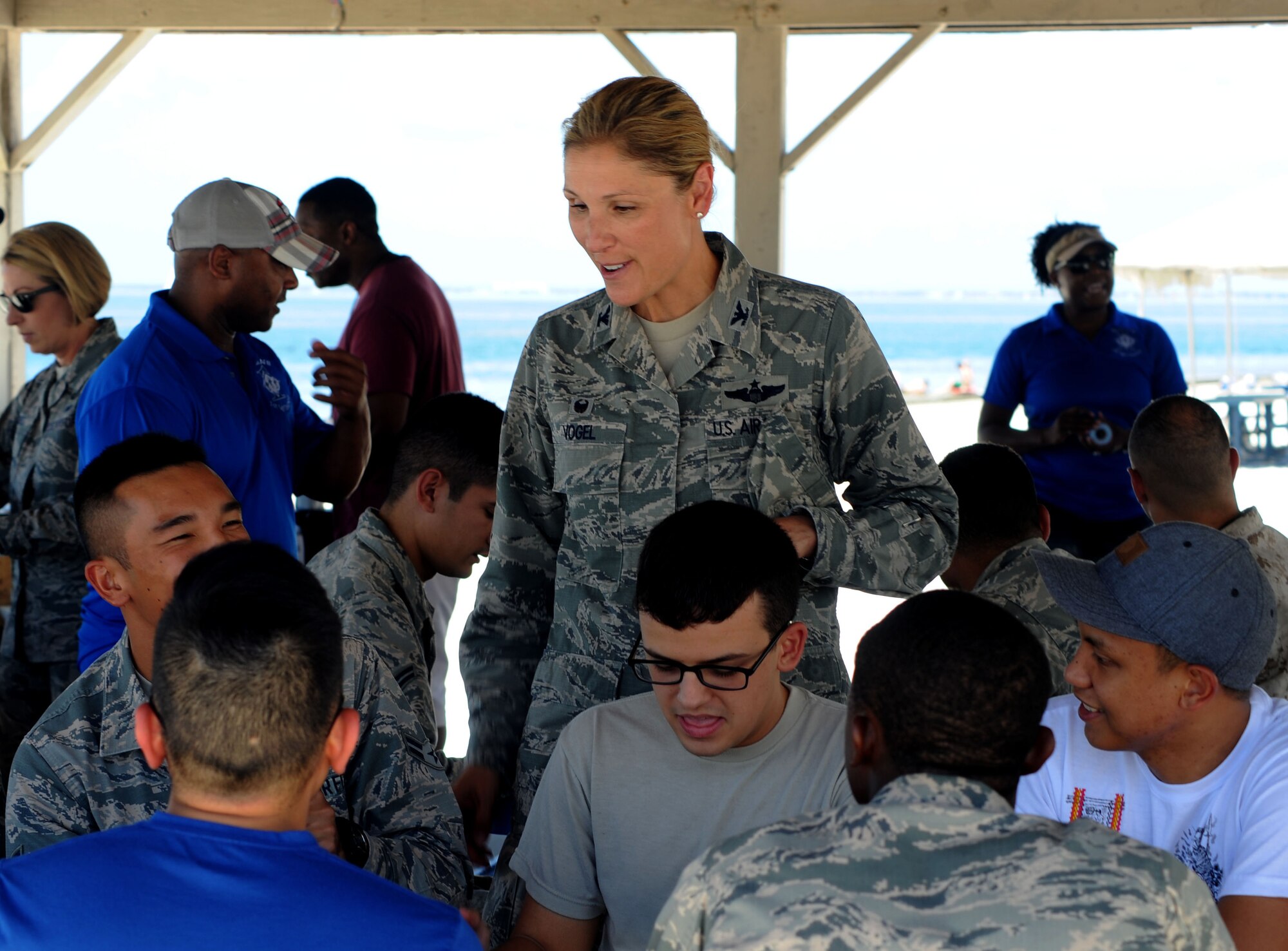 Col. April Vogel, commander of the 6th Air Mobility Wing, speaks with junior-enlisted dormitory residents during the Dorm Summer Bash at MacDill Air Force Base, Fla., July 27, 2016. MacDill’s First Sergeants Council and the 5/6 Council hosted the event to give the Airmen a day of fun at the beach. (U.S. Air Force photo by Airman Adam R. Shanks)