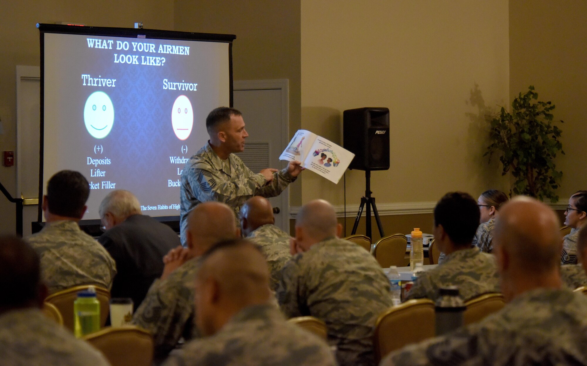Chief Master Sgt. Anthony Fisher, Profession of Arms Center of Excellence superintendent, reads from “Have You Filled a Bucket Today?” by Carol McCloud during an “Enhancing Human Capital” seminar, July 27, 2016, at Seymour Johnson Air Force Base, North Carolina. The seminar covered various topics including, phenomenon of entrenched thinking, the attributes and dangers of personal bias among many others. (U.S. Air Force photo by Airman Shawna L. Keyes) 
