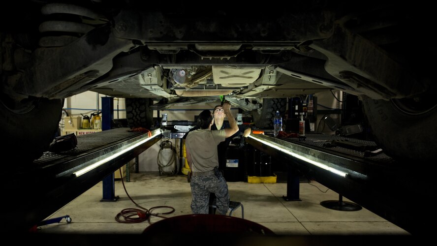 Staff Sgt. Adam Garcia (left) and Senior Airman Logan Rivelli, 5th Logistics Readiness Squadron vehicle maintenance technicians, inspect the underside of a Humvee in the Defender Dome at Minot Air Force Base, N.D., July 28, 2016. Airmen from the 5th LRS vehicle maintenance flight work to ensure that Team Minot stays mobile. (U.S. Air Force photos/Airman 1st Class J.T. Armstrong)