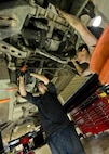 Senior Airman Logan Rivelli (left) and Staff Sgt. Adam Garcia, 5th Logistics Readiness Squadron vehicle maintenance technicians, inspect the underside of a Humvee in the Defender Dome at Minot Air Force Base, N.D., July 28, 2016. Airmen from the 5th LRS vehicle maintenance flight work to ensure that Team Minot stays mobile. (U.S. Air Force photos/Airman 1st Class J.T. Armstrong)