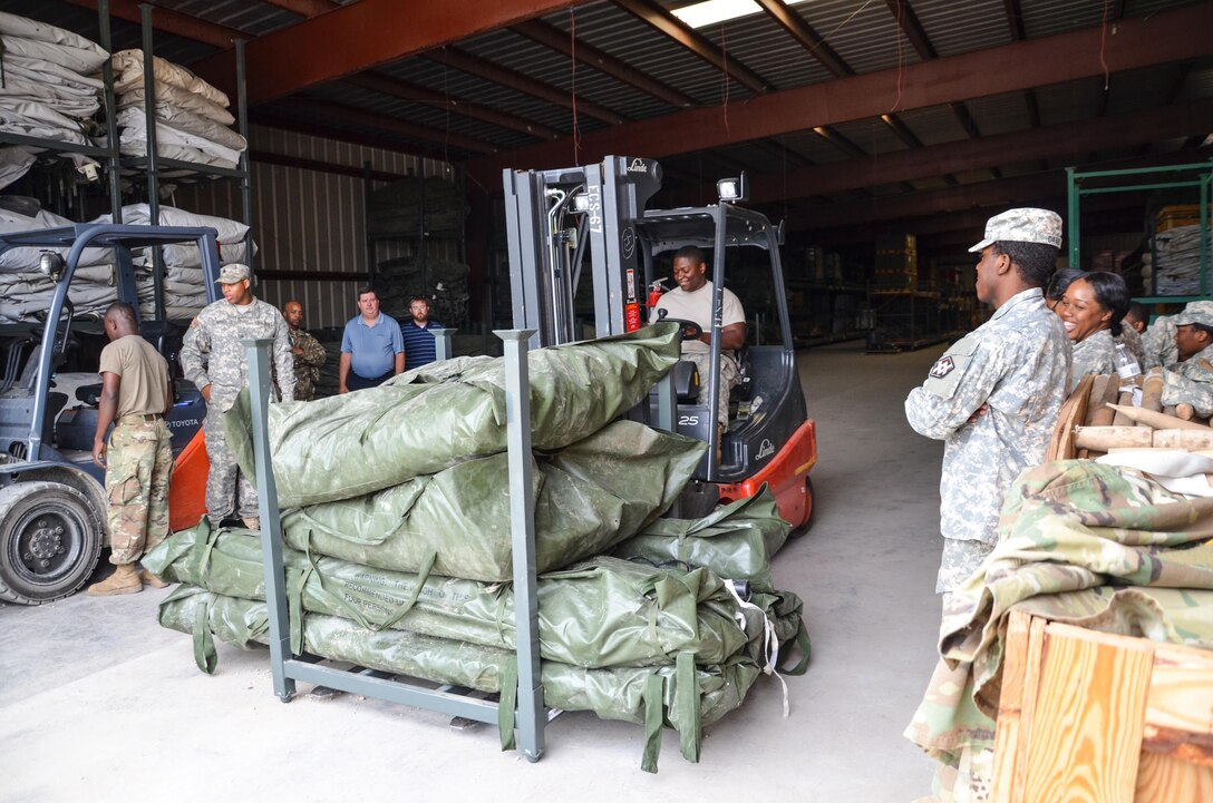 As part of their U.S. Army Reserve Annual Training participation in the 88th Regional Support Command's Operation Platinum Support mission, Soldiers from the 1015th Quartermaster out of Baltimore, Md., return tentage equipment to storage at the 88th RSC’s Equipment Concentration Site 67 on Fort McCoy, July 28. Operation Platinum Support allows Army Reserve Soldiers in low-density supply and maintenance specialties to perform and gain proficiency in their technical skills while acting in direct support to the numerous exercises taking place on Fort McCoy.