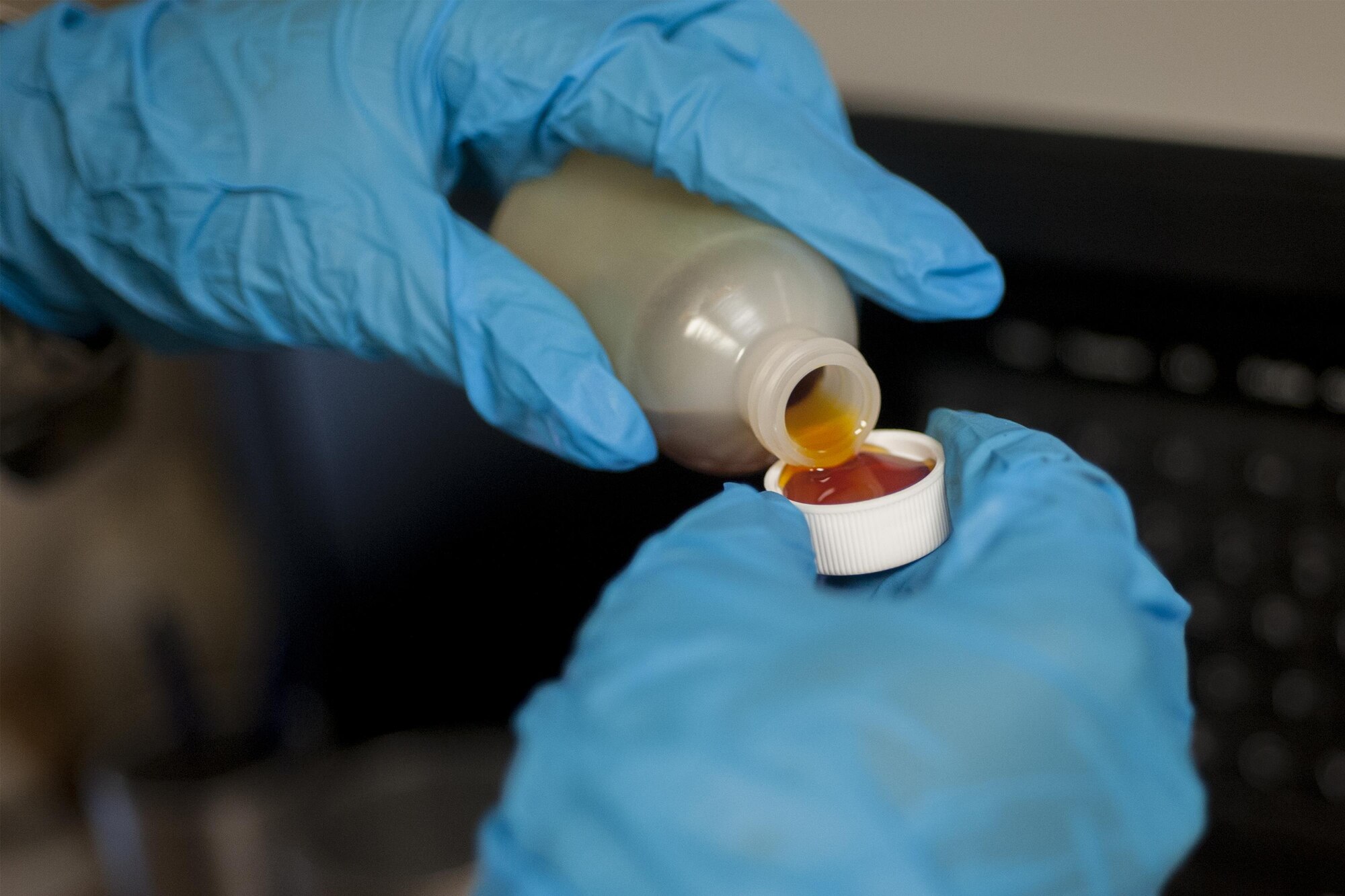 U.S. Air Force Airman 1st Class Diamond Anderson, 23d Equipment Maintenance Squadron non-destructive inspection apprentice, pours aircraft oil into a cap for testing, July 29, 2016, at Moody Air Force Base, Ga. NDI uses specialized equipment to test for different minerals in the oil to assess mechanical deficiencies inside the engines of aircraft. (U.S. Air Force photo by Airman Daniel Snider)
