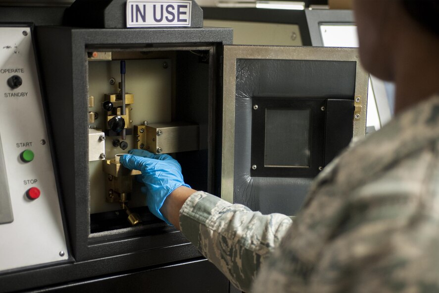 U.S. Air Force Airman 1st Class Diamond Anderson, 23d Equipment Maintenance Squadron non-destructive inspection apprentice, places a cap full of oil into a spectrometer, July 29, 2016, at Moody Air Force Base, Ga. The NDI unit’s responsibility is to detect defects in aircraft and supporting equipment. (U.S. Air Force photo by Airman Daniel Snider)