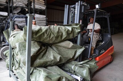 As part of their U.S. Army Reserve Annual Training participation in the 88th Regional Support Command's Operation Platinum Support mission, Soldiers from the 1015th Quartermaster out of Baltimore, Md., return tentage equipment to storage at the 88th RSC’s Equipment Concentration Site 67 on Fort McCoy, July 28. Operation Platinum Support allows Army Reserve Soldiers in low-density supply and maintenance specialties to perform and gain proficiency in their technical skills while acting in direct support to the numerous exercises taking place on Fort McCoy.