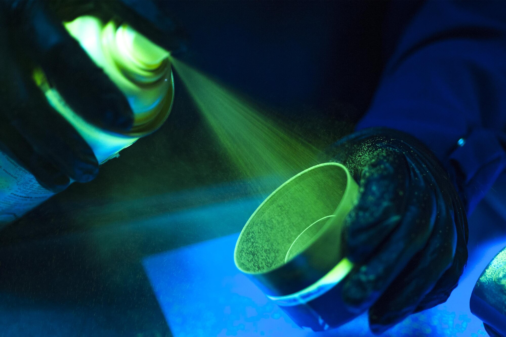 U.S. Air Force Airman Teanna Pafford, 23d Equipment Maintenance Squadron non-destructive inspection apprentice sprays a penetrating chemical into a cap before brushing it on to an aircraft part, July 29, 2016, at Moody Air Force Base, Ga. After NDI technicians find a problem, they send the part to the appropriate shop to be repaired. (U.S. Air Force photo by Airman Daniel Snider)
