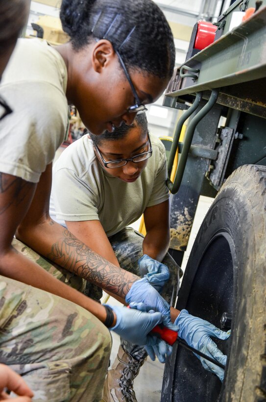 As part of their U.S. Army Reserve Annual Training participation in the 88th Regional Support Command's Operation Platinum Support mission, Spc. Kirsten Shavon Lee (left), Spc. Ashley Nicole Burks (right), with the 818th Support Maintenance Company out of Baltimore, Md., service the wheels on a portable generator at the 88th RSC’s Equipment Concentration Site 67 on Fort McCoy, July 28. Operation Platinum Support allows Army Reserve Soldiers in low-density supply and maintenance specialties to perform and gain proficiency in their technical skills while acting in direct support to the numerous exercises taking place on Fort McCoy.