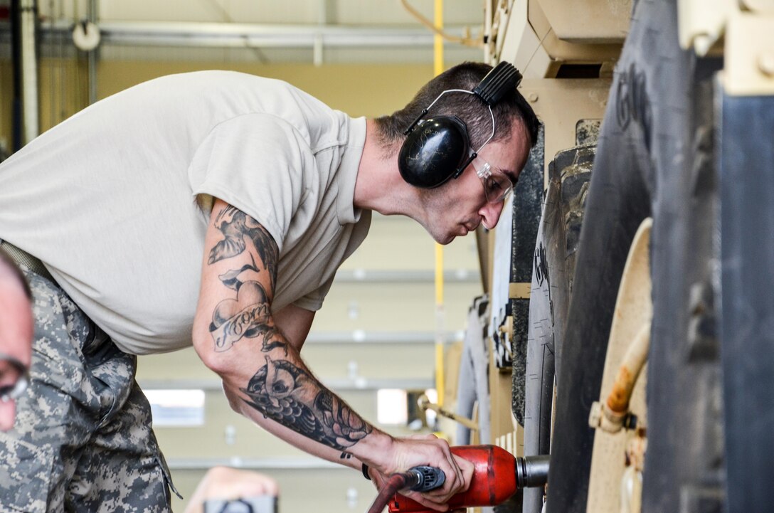 As part of his U.S. Army Reserve Annual Training participation in the 88th Regional Support Command’s Operation Platinum Support mission, Pfc. Christian Kaplan with the 298th Support Maintenance Company out of Altoona, Pa., removes the lug nuts from a FMTV to remove the wheels for annual service and maintenance at the 88th RSC’s Equipment Concentration Site 67 on Fort McCoy, July 28. Operation Platinum Support allows Army Reserve Soldiers in low-density supply and maintenance specialties to perform and gain proficiency in their technical skills while acting in direct support to the numerous exercises taking place on Fort McCoy.