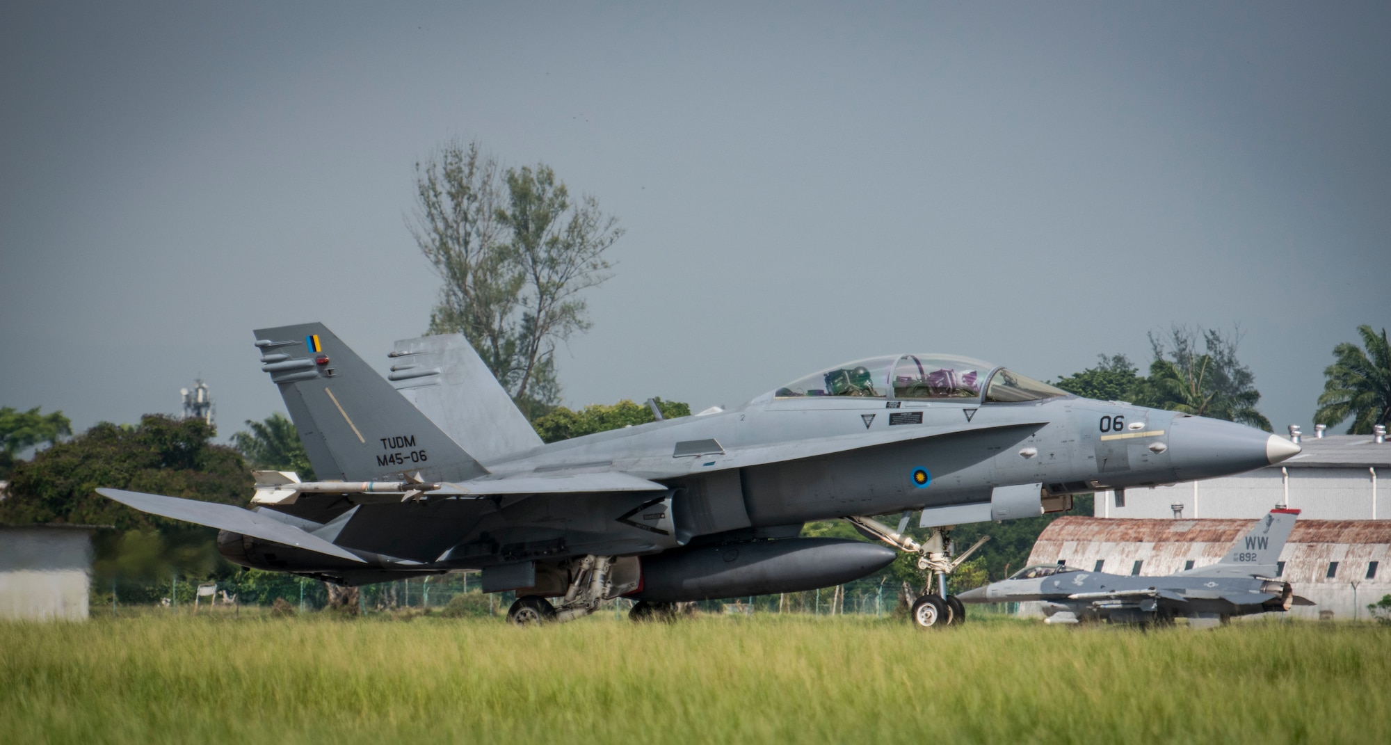 A Royal Malaysian Air Force F/A -18 D Hornet with the 18th Squadron, lands after training scenario during Cope Taufan 16, at Pangkalan Udara Butterworth Air Base, Malaysia July 22, 2016. This is the first time the RMAF is using the Joint Deployable Electronic Warfare Range system in both air and ground training. CT 16 is a Pacific Air Forces-led exercise that reinforces U.S. Pacific Command Theater Security Cooperation goals for the Southeast Asia region and demonstrates U.S. capability to project forces strategically in a combined, joint environment.  More than 450 Airmen are participating, as well as four U.S. Air Force airframes.  (U.S. Air Force photo by Tech. Sgt. Araceli Alarcon)