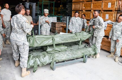 As part of their U.S. Army Reserve Annual Training participation in the 88th Regional Support Command's Operation Platinum Support mission, Soldiers from the 1015th Quartermaster out of Baltimore, Md., perform a two-person lift while stacking tentage before returning the equipment to storage at the 88th RSC’s Equipment Concentration Site 67 on Fort McCoy, July 28. Operation Platinum Support allows Army Reserve Soldiers in low-density supply and maintenance specialties to perform and gain proficiency in their technical skills while acting in direct support to the numerous exercises taking place on Fort McCoy.