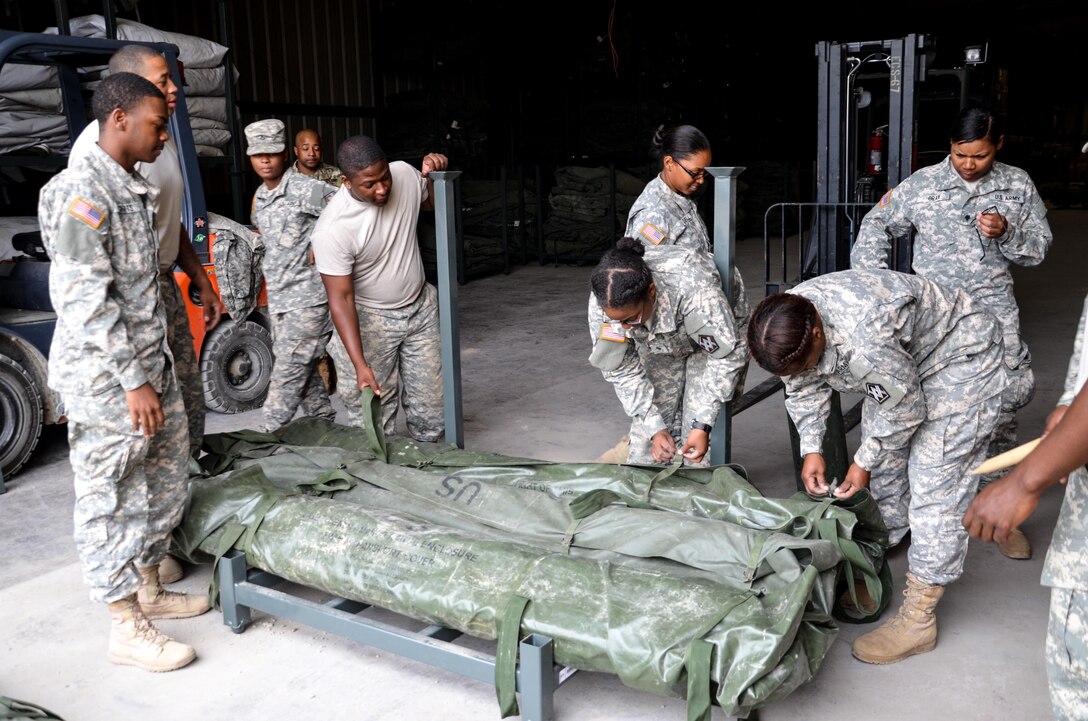 As part of their U.S. Army Reserve Annual Training participation in the 88th Regional Support Command's Operation Platinum Support mission, Soldiers from the 1015 Quartermaster out of Baltimore, Md., inspect the serviceability of tentage before returning the equipment to storage at the 88th RSC’s Equipment Concentration Site 67 on Fort McCoy, July 28. Operation Platinum Support allows Army Reserve Soldiers in low-density supply and maintenance specialties to perform and gain proficiency in their technical skills while acting in direct support to the numerous exercises taking place on Fort McCoy.