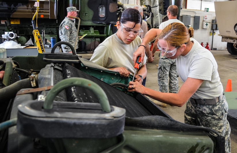 As part of their U.S. Army Reserve Annual Training participation in the 88th Regional Support Command's Operation Platinum Support mission, Spc. Kelly Simmons and Pfc. Lorraine Irizarry, 698th Quartermaster Company out of Nicholas, New York, remove a radiator as part of an engine repair on a HMMWV at the 88th RSC’s Equipment Concentration Site 67 on Fort McCoy, July 28. Operation Platinum Support allows Army Reserve Soldiers in low-density supply and maintenance specialties to perform and gain proficiency in their technical skills while acting in direct support to the numerous exercises taking place on Fort McCoy.