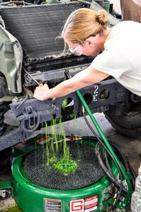 As part of her U.S. Army Reserve Annual Training participation in the 88th Regional Support Command's Operation Platinum Support mission, Spc. Kelly Simmons, 698th Quartermaster Company out of Nicholas, New York, drains a radiator as part of an engine repair on a HMMWV at the 88th RSC’s Equipment Concentration Site 67 on Fort McCoy, July 28. Operation Platinum Support allows Army Reserve Soldiers in low-density supply and maintenance specialties to perform and gain proficiency in their technical skills while acting in direct support to the numerous exercises taking place on Fort McCoy.