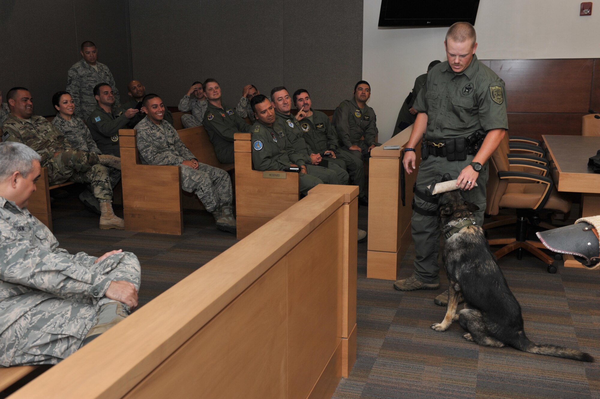 Derek York, an Okaloosa County K-9 team member, performs obedience drills with his working dog, Ranger, during the Building Partnership Aviation Capacity Seminar at Ft. Walton Beach, Fla., July 19, 2016. Approximately 40 guest speakers amd tour guides from across the Department of Defense, other government agencies and the civilia sector share their personal experiencies in aviations enterprise and security with BPACS attendees. (U.S. Air Force photo by Staff Sgt. Kentavist P. Brackin)