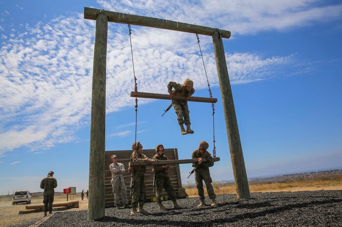 Recruits from Hotel Company, 2nd Recruit Training Battalion, climb Jenkin’s Pinnacle during the Crucible at Marine Corps Base Camp Pendleton, Calif., July 27. For this obstacle, recruits had to find a way to get themselves, and four ammunition cans, over two hanging bars. Annually, more than 17,000 males recruited from the Western Recruiting Re¬¬gion are trained at MCRD San Diego. Hotel Company is scheduled to graduate Aug. 5.