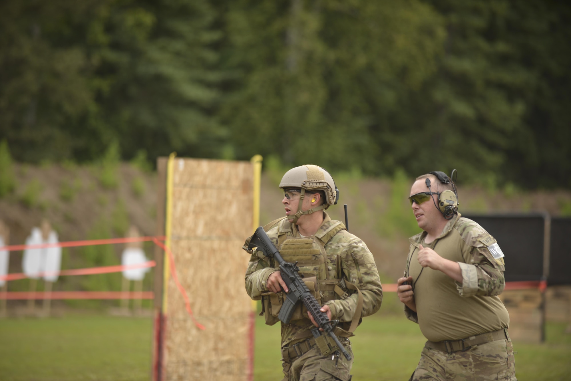 U.S. Air Force Senior Airman Isaac Heustess, a 3rd Air Support Operations Squadron, Joint-Base Elmendorf-Richardson, Alaska, tactical air control party specialist, runs through the stress shooting course as part of Cascade Challenge July 20, 2016, at a practice range in Delta Junction, Alaska. Competitors had to perform maneuvers with the distraction of ambient blank cartridge blasts, simulating the stress of a live combat engagement. (U.S. Air Force photo by Airman Isaac Johnson)