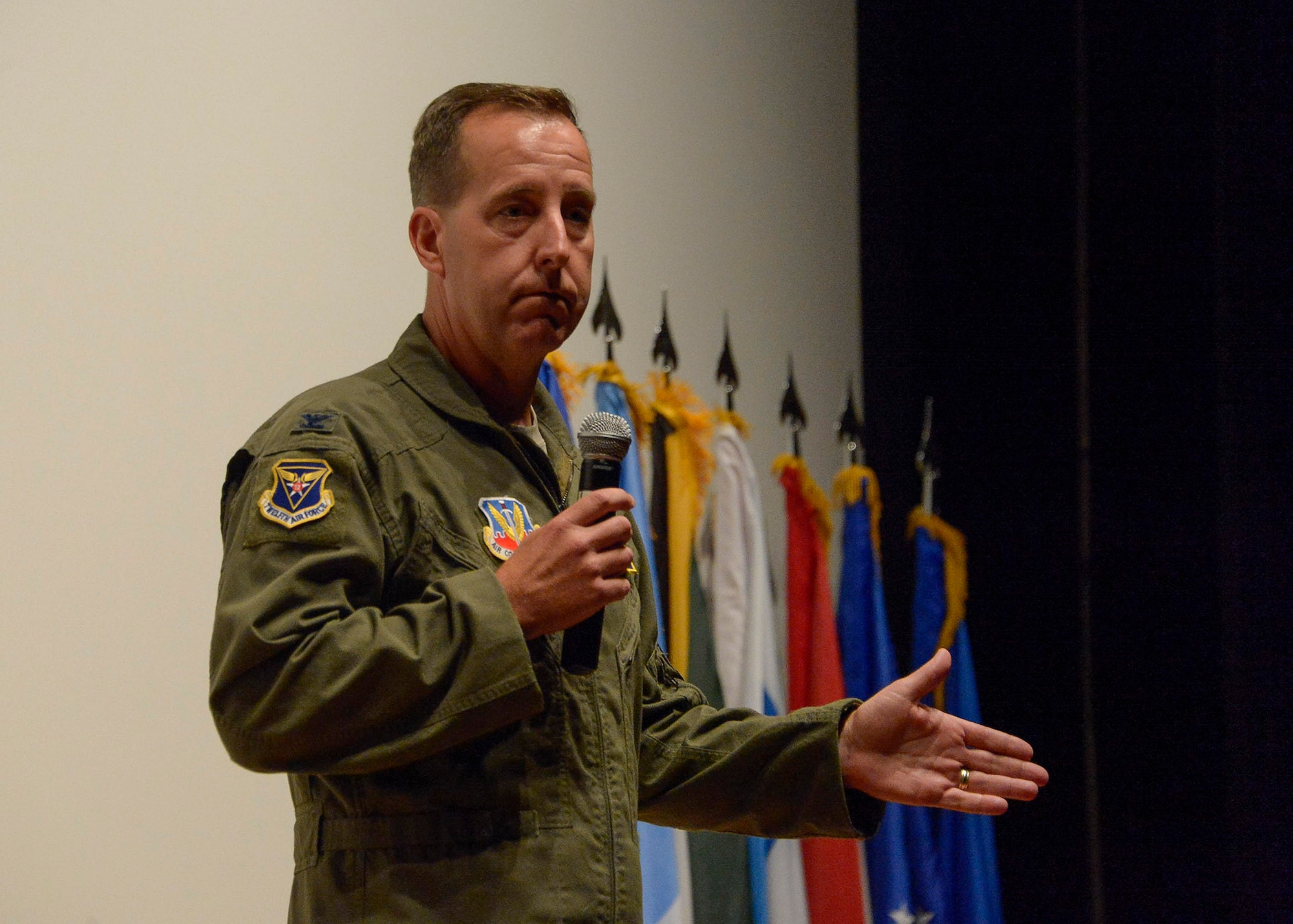 U.S. Air Force Col. Jay Bickley, 12th Air Force (Air Forces Southern) vice commander, welcomes service members from twelve different nations to Davis-Monthan AFB during a briefing on the upcoming PANAMAX exercise at the base theater on Davis-Monthan AFB, Ariz., July 26, 2016. Nineteen total nations are joining the United States for a seven-day exercise that will use simulations to command and control multinational notional sea, air, cyber and land forces defending the vital waterway and surrounding areas against threats from violent extremism and to provide for humanitarian relief, as necessary. The PANAMAX exercise goal is to increase the ability of nations to work together, enable assembled forces to organize as a multination task force and test their responsiveness in combined operations. (U.S. Air Force photo by Tech. Sgt. Heather R. Redman)