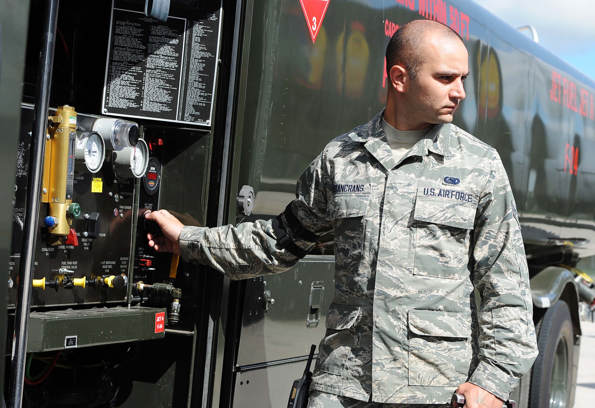 Senior Airman Roger Rosancrans, 5th Logistics Readiness Squadron fuels distribution operator, looks on as a B-52H Stratofortress is being fueled at Minot Air Force Base, N.D., July 28, 2016. Rosancrans helps fuel all the aircraft on Minot AFB. (U.S. Air Force photo/Senior Airman Kristoffer Kaubisch)