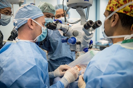 (July 21, 2016) Cmdr. John Cason (Left), an optomologist, and Capt. Sayjel Patel, an optomologist, both assigned to hospital ship USNS Mercy (T-AH 19) and local Vietnamese optomologists perform eye surgery on a Vietnamese man aboard Mercy. Pacific Partnership and local Vietnamese doctors worked side-by-side during four different surgeries exchanging best practices, ideas and methods of treatment. Mercy is joined in Da Nang by JS Shimokita (LST-4002) and Vietnam People's Navy ship Khánh Hóa for Pacific Partnership. Partner nations are working side-by-side with organizations to conduct cooperative health engagements, community relation events and subject matter expert exchanges to better prepare for natural disaster or crisis. 