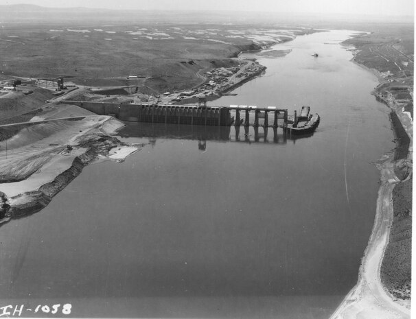 Ice Harbor Lock and Dam upstream of the Tri-Cities on the Lower Snake River celebrated its 50th anniversary of construction by the U.S. Army Corps of Engineers, June 16, 2012 at the dam. It was built from 1956 to 1962 and dedicated by Vice-President Lyndon B. Johnson on May 9, 1962. Corps of Engineers photos. (Looking West at South shore construction, dredge in background)