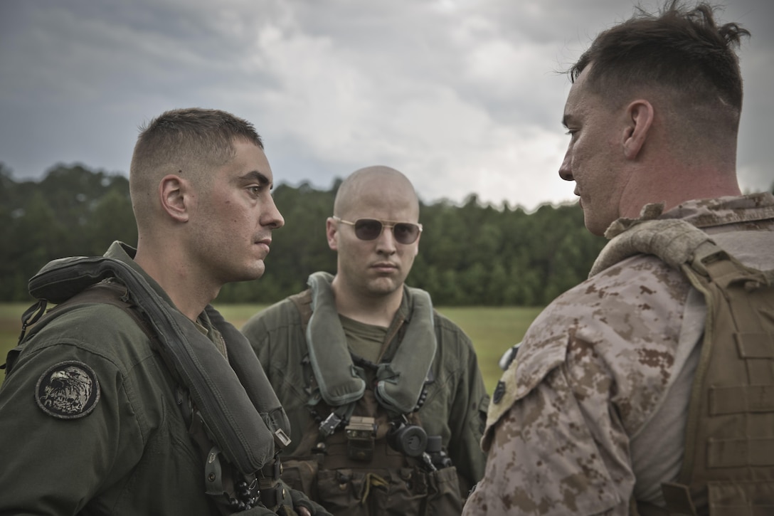 U.S. Marine Corps Staff Sgt. Dustin P. Yurcisin (Right), a basic landing support specialist instructor assigned to Logisitics Operations School (LOS), Marine Corps Combat Service Support Schools, speaks to crew chiefs assigned to Marine Heavy Helicopter Squadron (HMH) 464, during a Helicopter Support Team (HST) training exercise at Camp Lejeune, N.C., July 19, 2016. Students attending LOS performed HST exercises as part of their required entry-level training. (U.S. Marine Corps photo by Lance Cpl. Manuel A. Serrano)