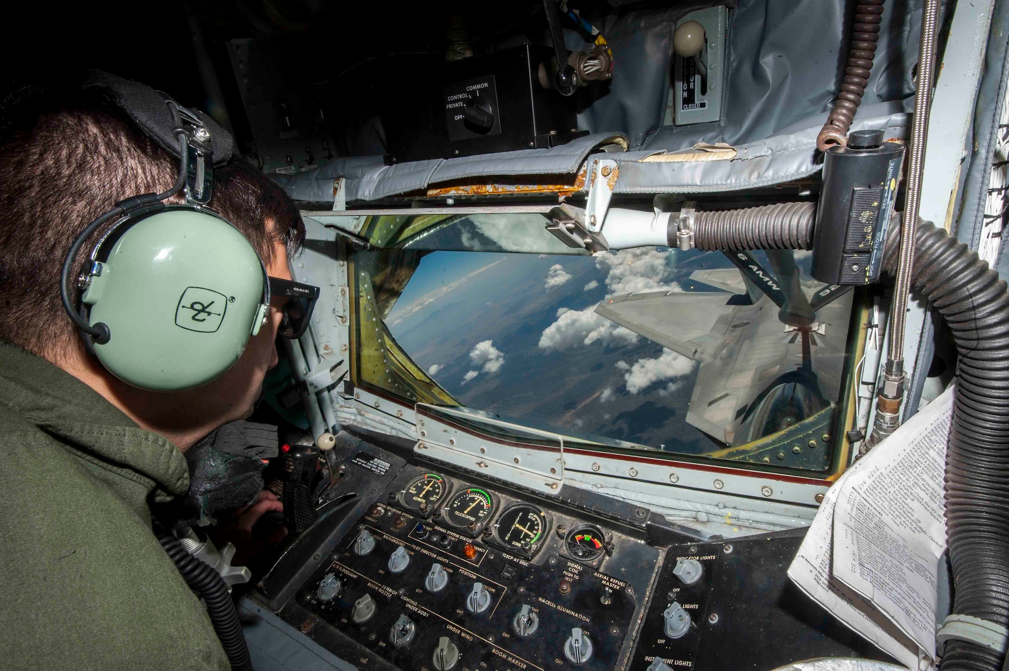 Senior Airman Eric Medina, 92nd Air Refueling Squadron boom operator, Fairchild Air Force Base, Wash., refuels an F-22 Raptor from Joint Base Langley-Eustis, Va., in a training sortie during Red Flag 16-3, July 21, 2016. During Red Flag, Medina is in charge of refueling aircraft that are participating in the exercise so they can continue the fight without having to return to Nellis AFB, Nev., for fuel. (U.S. Air Force photo by Senior Airman Jake Carter/Released)