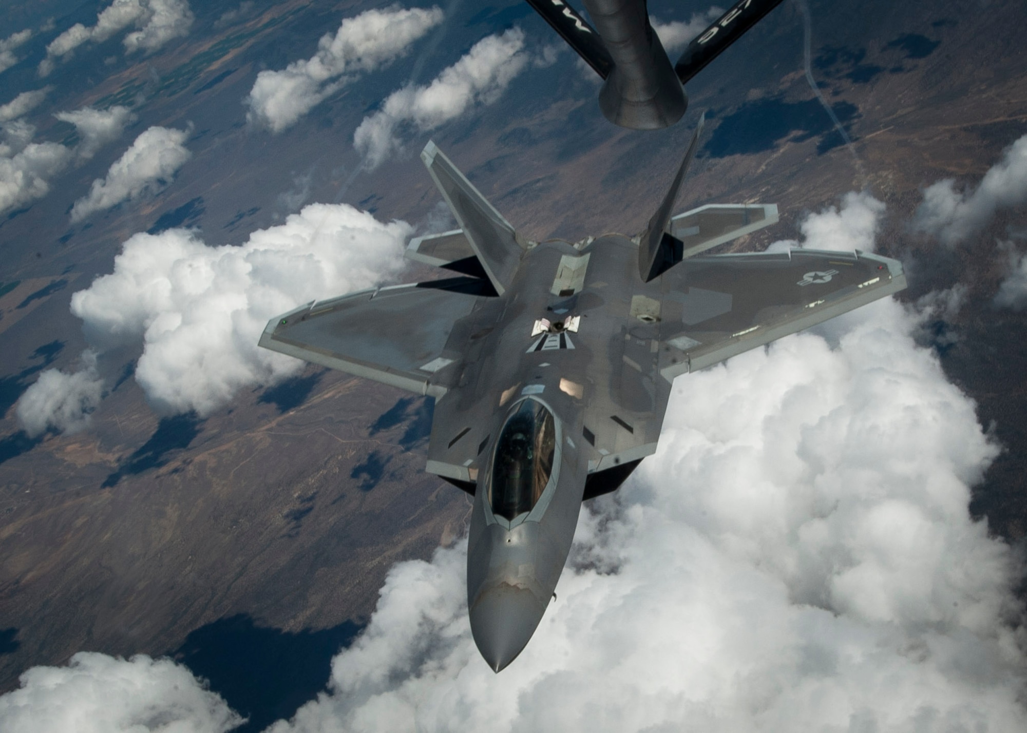 An F-22 Raptor, from Joint Base Langley-Eustis, Va., banks off after receiving fuel from a KC-135 Stratotanker over the Nevada Test and Training Range in a training sortie during Red Flag 16-3, July 21, 2016. During Red Flag 16-3, units from the U.S. Air Force, Marine Corps and Navy will work together to succeed in air, space and cyberspace. (U.S. Air Force photo by Senior Airman Jake Carter/Released)