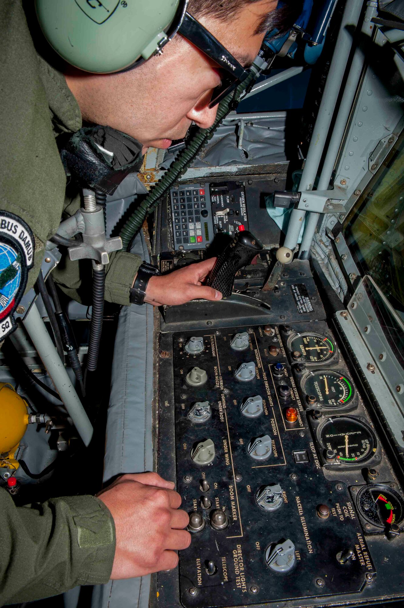 Senior Airman Eric Medina, 92nd Air Refueling Squadron boom operator, Fairchild Air Force Base, Wash., refuels an F-22 Raptor from Joint Base Langley-Eustis, Va., in a training sortie during Red Flag 16-3, July 21, 2016. While refueling aircraft, Medina is in charge of thousands of pounds of fuel that will be supplied to aircraft using a KC-135 Stratotanker in the sky. (U.S. Air Force photo by Senior Airman Jake Carter/Released)