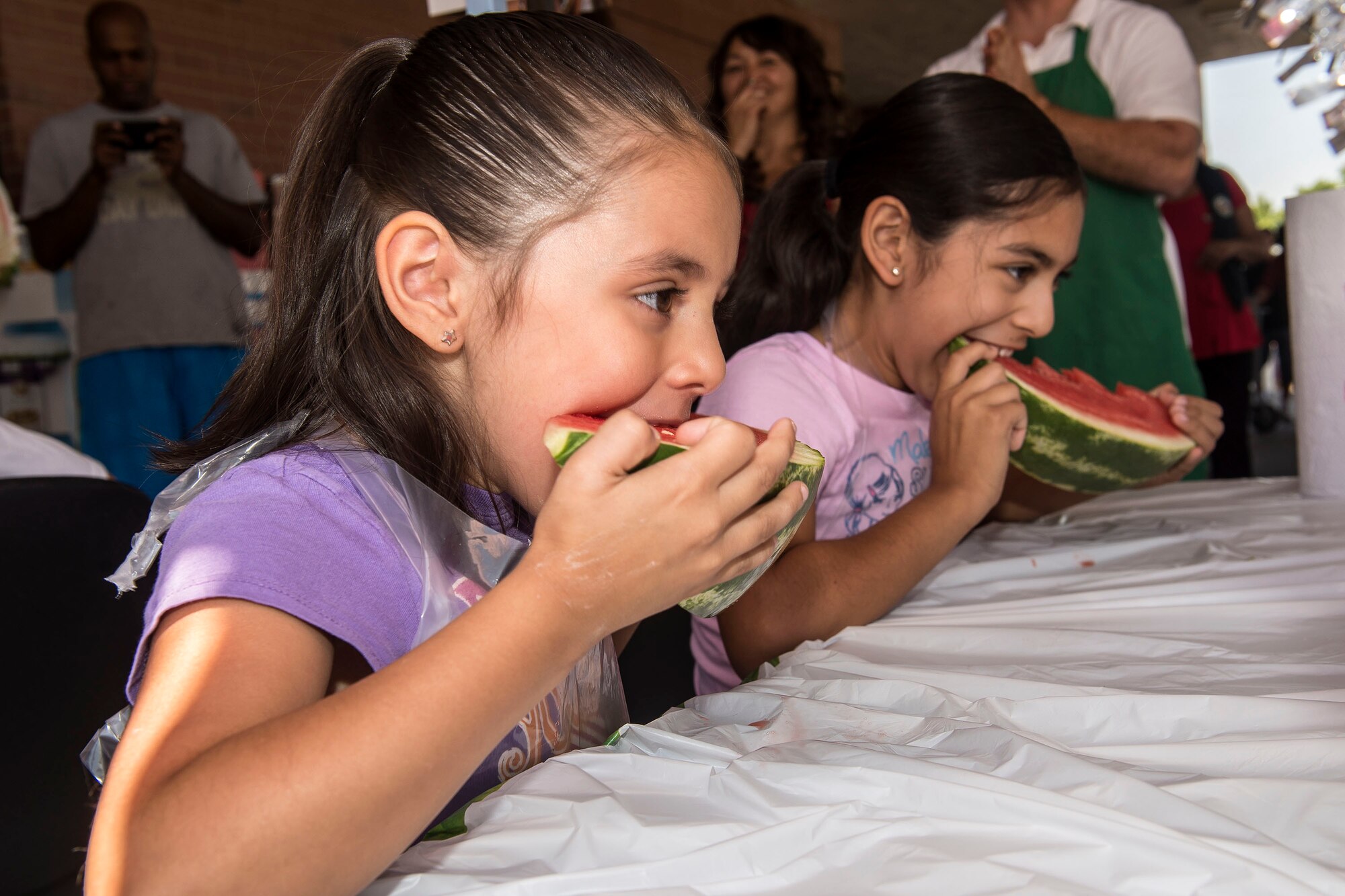 Sophie and Chantel Bailey, daughters of Staff Sgt. Quenton Bailey, 729th Air Control Squadron, participate in a watermelon eating contest July 29 at the Hill Air Force Base commissary. The contest was just one activity provided by the Defense Commissary Agency as part of the annual ‘Your Healthy Lifestyle Festival.’ Produce was discounted and healthy lifestyle information was made available to commissary patrons. (U.S. Air Force photo by Paul Holcomb)