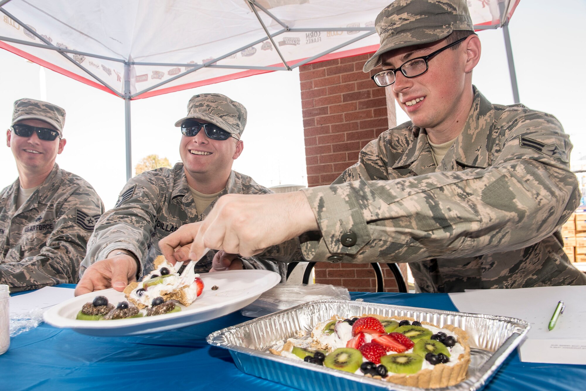 From the left, 75th Logistics Readiness Squadron Airmen Tech. Sgt. Chris McFadden, Tech. Sgt. John Dillard, and Airman 1st Class Taylor Bentley judge a protein crust fruit tart during the ‘healthy dish’ contest July 29 at the Hill Air Force Base commissary. The Defense Commissary Agency hosted the event as part of the ‘Your Healthy Lifestyle Festival.’ (U.S. Air Force photo by Paul Holcomb)