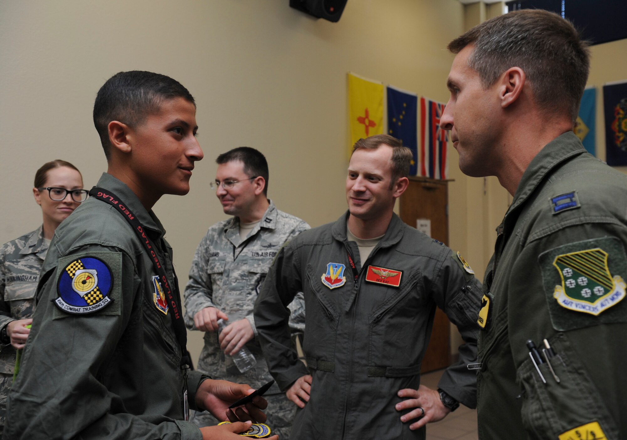 Reymond meets with Red Flag key players during his visit to Nellis Air Force Base, Nev., on July 19, 2016. Capt. Robert Hansen, 27th Fighter Squadron F-22 aircraft commander at Langley AFB, Virginia shares encouraging words regarding his cancer survival story. (U.S. Air Force photo by Staff Sgt. Darlene Seltmann)
