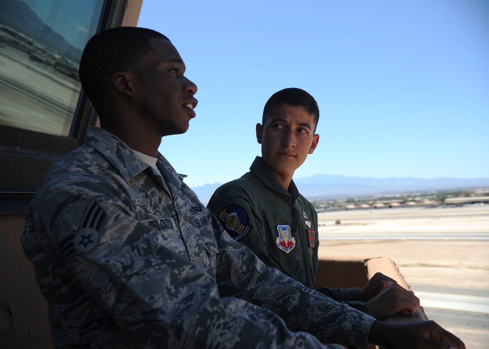 Senior Airman Nathaniel Deloatch, 57th Operations Support Squadron air traffic controller, gives Reymond a first-hand glimpse on what it’s like to be in the air traffic control tower during a Red Flag exercise at Nellis Air Force Base, Nev., July 19, 2016. Approximately 100 aircraft and 3,500 participants from 40 U.S. military units are participating in Red Flag 16-3. (U.S. Air Force photo by Staff Sgt. Darlene Seltmann)