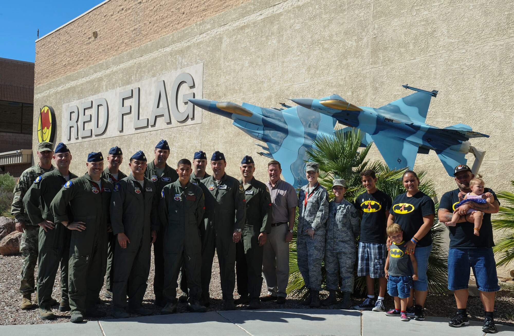 Key Players of the Red Flag exercise and the Rivas-Cook family pose for a photo in front of the Red Flag building at Nellis Air Force Base, Nev., July 19, 2016. One of Reymond’s wishes was to come to Nellis AFB during a Red Flag exercise. (U.S. Air Force photo by Staff Sgt. Darlene Seltmann)