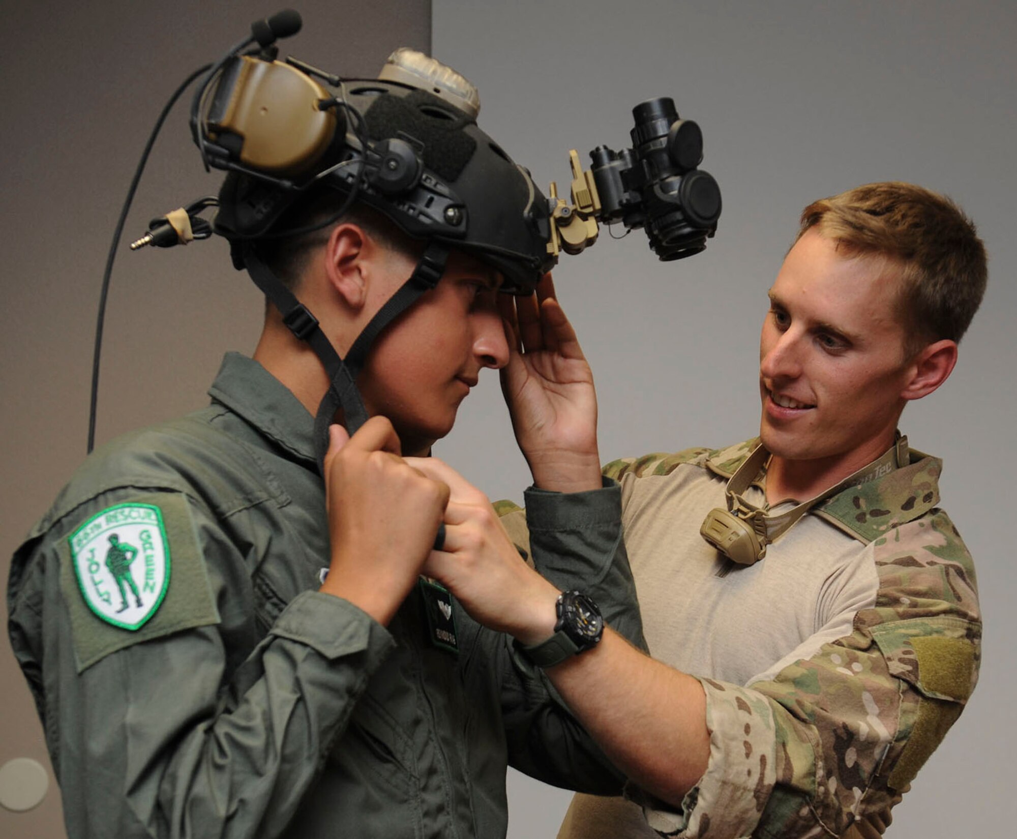 A pararescueman shows Reymond their night vision equipment during his visit to the 66th Rescue Squadron at Nellis Air Force Base, Nev., July 19, 2016. In addition to visiting with the pararescuemen, Reymond got a first-hand look inside the HH-60. (U.S. Air Force photo by Staff Sgt. Darlene Seltmann)