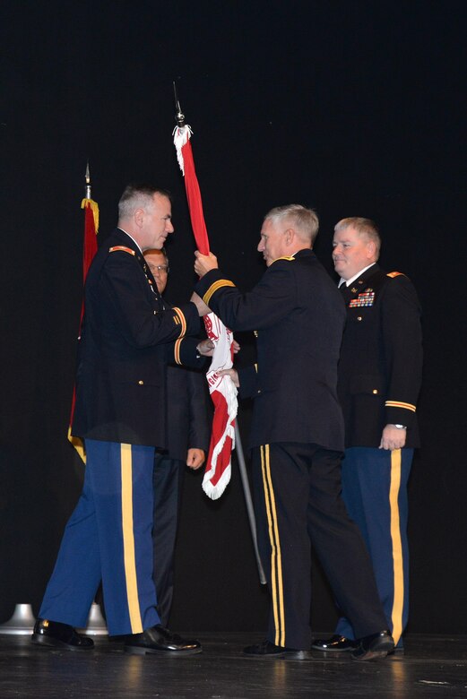 U.S. Army Corps of Engineers Deputy Chief of Engineers and  Deputy Commanding General Maj. Gen. Richard Stevens passes the guidon to Col. John Hurley during the July 29 change of command at Chan Auditorium on the UAH campus. Outgoing interim commander Lt. Col. Burlin Emery will return to his position as deputy commander.
