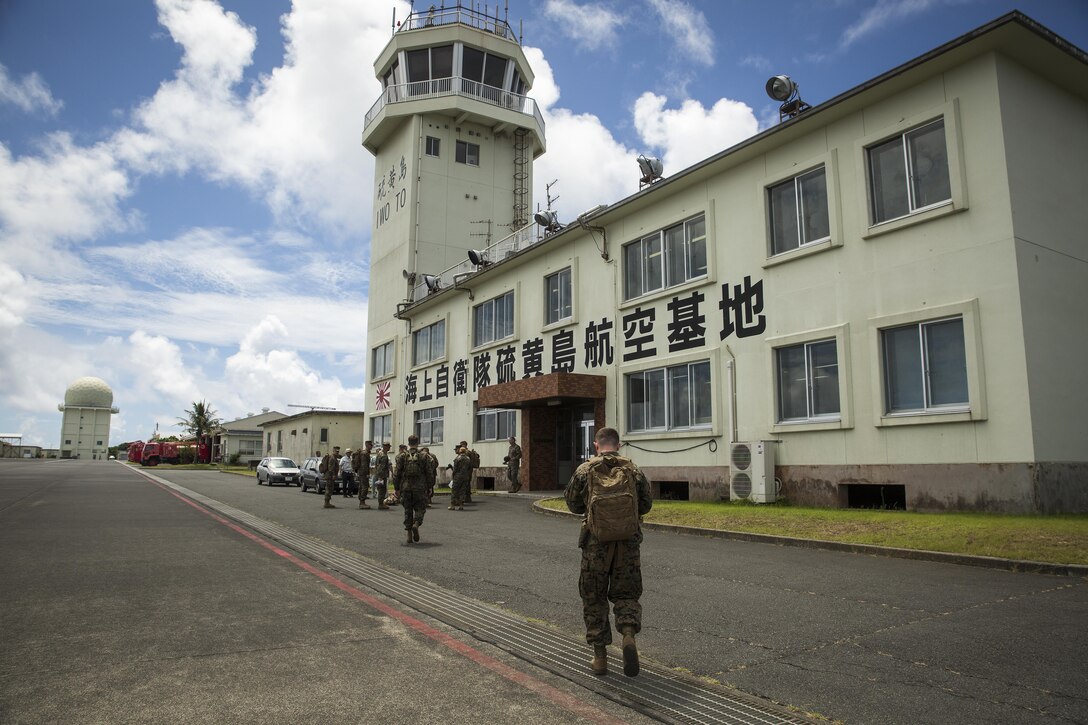 Marines and Sailors muster by the air traffic control tower on Iwo To, Japan, July 7, 2016. The service members flew to Japan and participated in a guided discussion on the importance of Iwo Jima during World War II and visited the island to honor those who gave their lives. (U.S. Marine Corps photo by Sgt. Matthew J. Bragg)