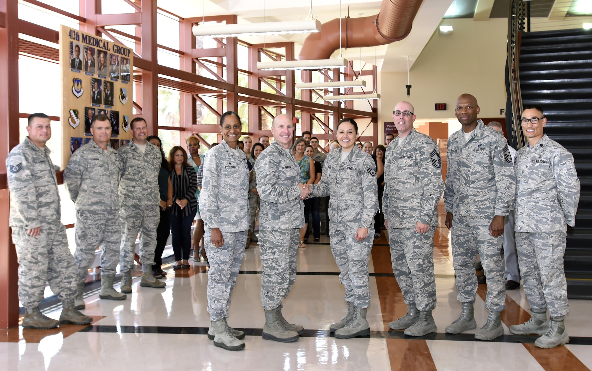 Staff Sgt. Raquel Caramanno, 412th Medical Group, is congratulated by Brig. Gen. Carl Schaefer, 412th Test Wing commander, and the 412th MDG team, during the announcement of her selection as one of the 12 Air Force Outstanding Airmen of the Year.  Pictured, left to right: 412th Medical Group commander, Col. Karen Dean-Cox; Brig. Gen. Carl Schaefer, Staff Sgt. Racquel Caramanno; Chief Master Sgt. Anthony Soto, 412th MDG; Chief Master Sgt. Todd Simmons, 412th TW command chief; and Lt. Col. David Huinker, 412th Medical Support Squadron commander. (U.S. Air Force photo by Dawn Waldman)